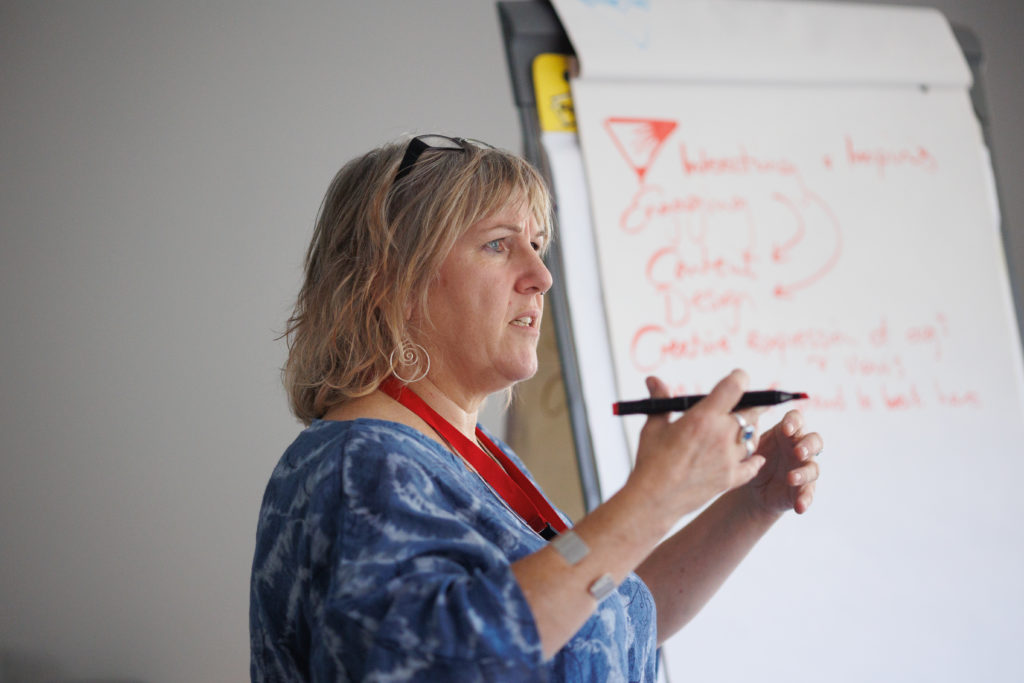 woman speaking at a whiteboard